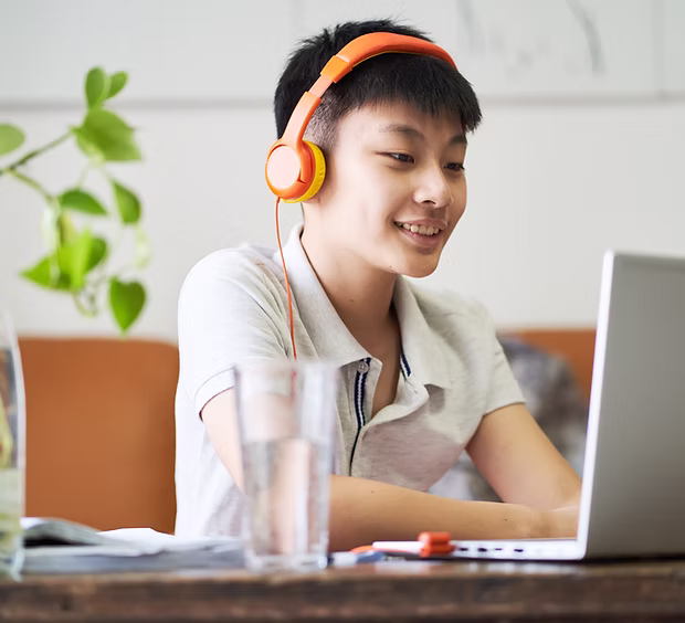 Student reviewing essay with headphones